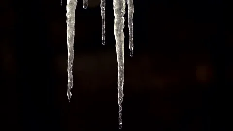 Slow motion close up macro shot of melting ice stalactite and water drops Stock Footage 148076302