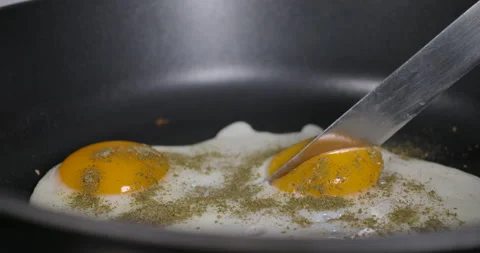 Slow Motion Close Up Man Cooking Fried Eggs on Frying Pan For Breakfast, Kitc Stock Footage 148157320