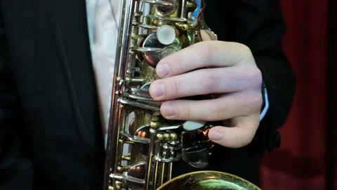 SLOW MOTION close up of man playing on old saxophone. Jazz player rehearsing Stock Footage 106327973