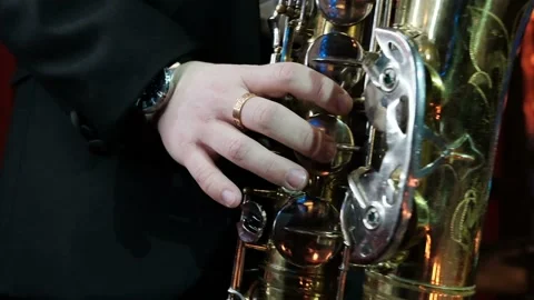 SLOW MOTION close up of man playing on old saxophone. Jazz player rehearsing Stock Footage 106327990