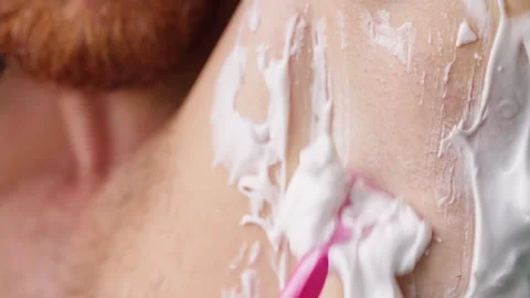 Slow Motion Close Up of a Man Shaving Armpit Hair with a Pink Razor And Shaving Stock Footage 342617348
