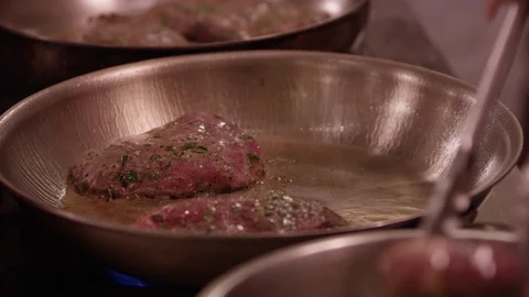 Slow motion close up of meat cooking in fry pan Stock Footage 113726600