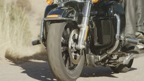 Slow motion close up of motorcycle wheel driving on pavement Stock Footage 227444173