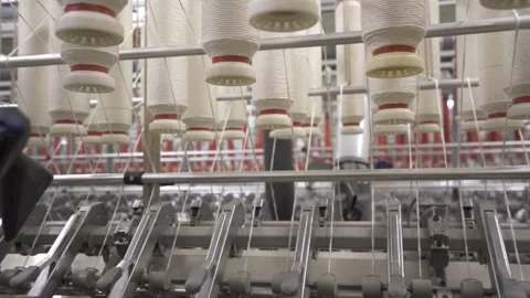 Slow motion close up of multiple cotton reels in spinning mill machines Stock Footage 257763425