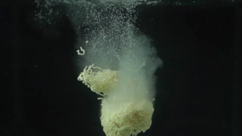 Slow Motion Close Up Of Noodles Being Dropped Into Water Stock Footage 195638869
