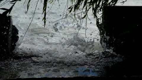 SLOW MOTION, CLOSE UP: ocean swell hits the rocky shore and splashes high in the Stock Footage 245948205