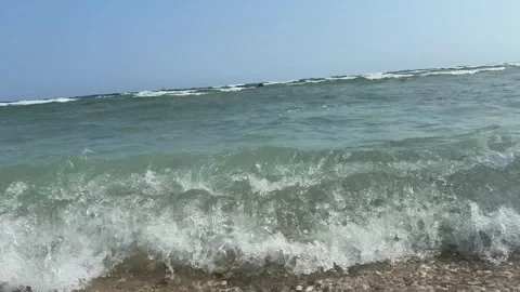Slow Motion Close-up of Ocean Waves Crashing on Sand Beach Video stock 330703397