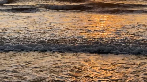 Slow motion close up of ocean waves rolling at golden sunset with sun light Stock Footage 342218926