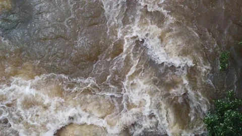 Slow motion Close Up Overhead view looking down at river rocks in a swift fast m Stock Footage 286866834