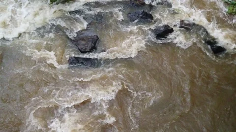 Slow motion Close Up Overhead view looking down at river rocks in a swift fast m Stock Footage 286867928