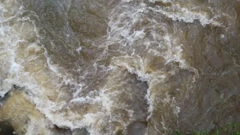Slow motion Close Up Overhead view looking down at river rocks in a swift fast m Stock Footage 286868298