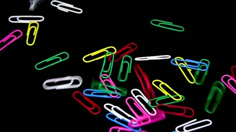 Slow Motion Close Up Paper Clip Colorful Isolated in Black Video stock 160422540