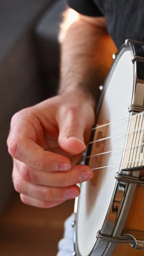 Slow Motion Close-up of Person Hand Fingerpicking Banjolele Strings Stock Footage 332906881