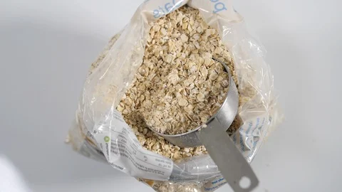 Slow motion close up of a plastic bag of porridge breakfast oats Stock Footage 88338476