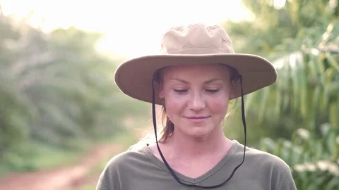 Slow motion. Close up portrait of happy young woman gardener in a hat smiling Stock Footage 87474866