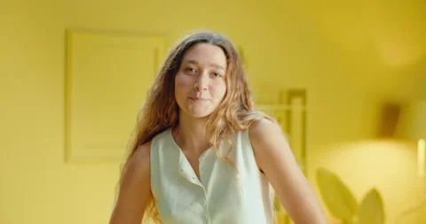 Slow motion of close up portrait of a pretty young brunette woman in sleeveless Stock Footage 188094980