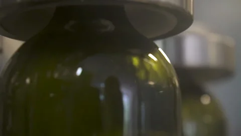 Slow motion, close-up pour wine into a bottle, on the conveyor belt. Stock Footage 155427237