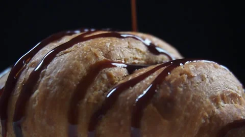 Slow motion close up of pouring chocolate cream over croissant Stock Footage 278150481