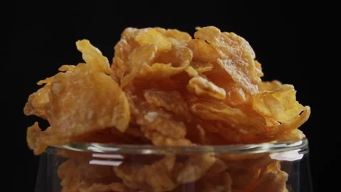 Slow motion close up of pouring corn flakes into empty clear glass Stock Footage 279700440