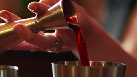 Slow Motion Close Up of Pouring Red Liqueur from Jigger Stock Footage 346105312