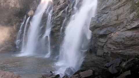 Slow Motion Close Up Of Powerful Waterfall Crashing Into Dark Rocks Stock Footage 340470165