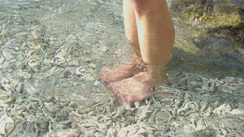 Slow Motion - Close up of Pretty woman's legs and feet move through clear topica Stock-Footage 113404534