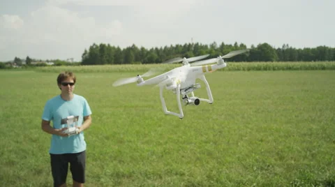 SLOW MOTION CLOSE UP: Professional pilot flying DJI Phantom drone Stock Footage 53818617