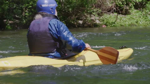 Slow motion close up rack focus of older male kayaker in alpine river Stock Footage 204715191
