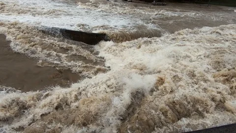 Slow motion close up raging chaotic water flowing in wide flooded river Stock Footage 121929664