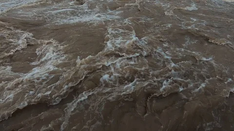 Slow motion close up raging chaotic water flowing in wide flooded river Stock Footage 122036187