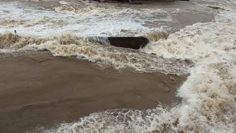 Slow motion close up raging water flowing in wide flooded river Stock Footage 121929678