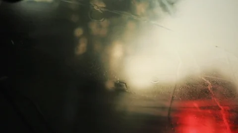 Slow motion close up rain flows and wipers on the front windshield glass window Stock Footage 94531354