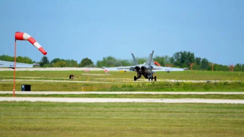 Slow motion close up rear view of two F-18 fighter jets taxi on the taxiway and Stock Footage 318050177
