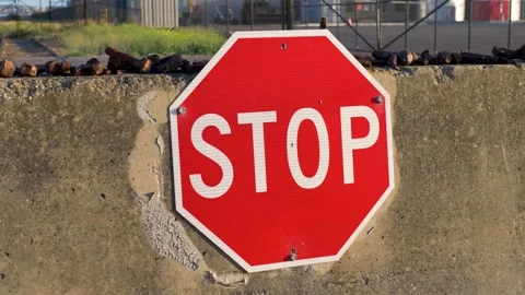 Slow motion close-up of a red and white octagonal metal stop sign with Stock Footage 346107178