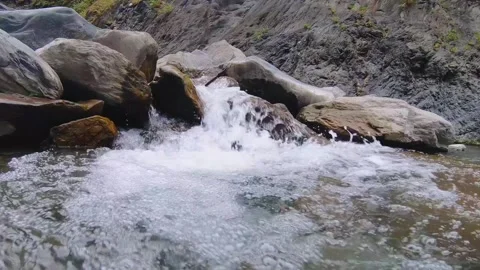 Slow motion close up to river water surged rapidly with speed raced downstream b Stock Footage 265491629
