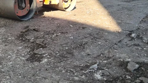 Slow Motion Close-up of Road Roller Drum Compacting Soil Stock Footage 334456476