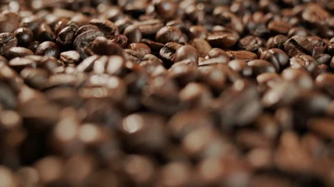 Slow motion close up of roasted coffee beans rotating on wooden surface wit.. Stock Footage 334601830