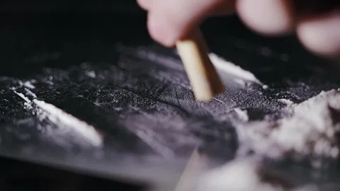 Slow Motion Close Up of Rolled Euro Banknote Snorting Cocaine on Glass Table 動画素材 318947830