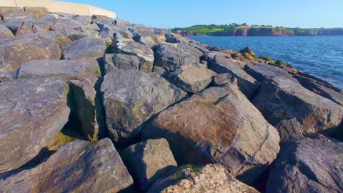 Slow motion close up of rough stone coastal cliff surface Stock Footage 340452182