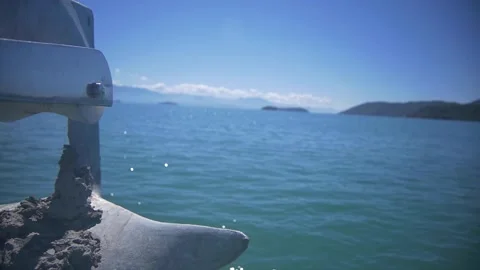 Slow motion, close up of sailing boat anchor moving above the water Stock Footage 255867388