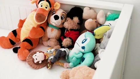 Slow motion close-up of several stuffed animals piled in the corner of a Stock Footage 239637157