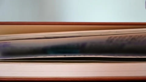 SLOW MOTION CLOSE UP shallow focus shot of a leather bound book being closed Stock Footage 148339268