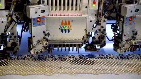 Slow motion close up shot of automatic embroidery machine in textile factory Stock Footage 199271027