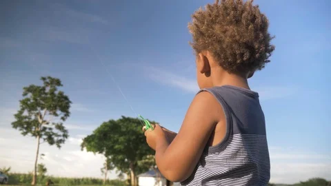 Slow motion close up shot behind a young mixed raced boy holding onto a Stock Footage 108473395
