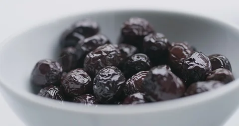 Slow motion close up shot of black olives on breakfast table. Stock Footage 91009316