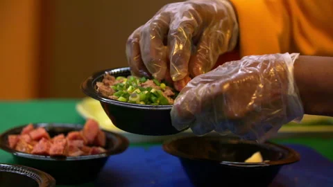 Slow Motion Close-Up Shot Of Chef Wearing Plastic Gloves Putting Ingredients In Stock Footage 237056769