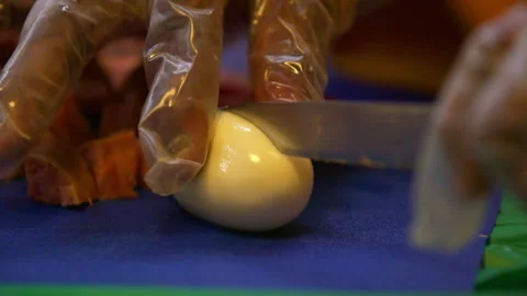 Slow Motion Close-Up Shot Of Chef Wearing Plastic Gloves Cutting Boiled Egg - Stock Footage 237094240