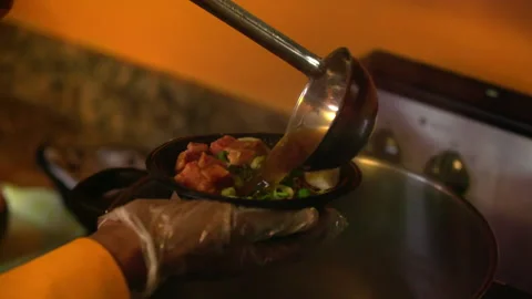 Slow Motion Close-Up Shot Of Chef Wearing Plastic Gloves Putting Soup In Bowl Of Stock Footage 237130266