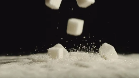 SLOW MOTION: Close shot of cubes of sugar falling in sugar Stock Footage 107501282