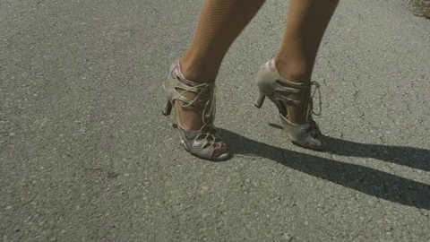Slow motion close up shot dancer foot dancing with high heels on a road. Stock Footage 116688036